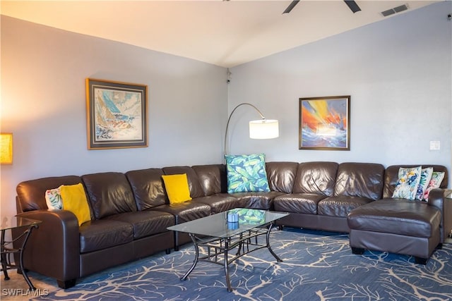 living room with visible vents, vaulted ceiling, and a ceiling fan