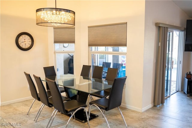 dining room with an inviting chandelier and baseboards