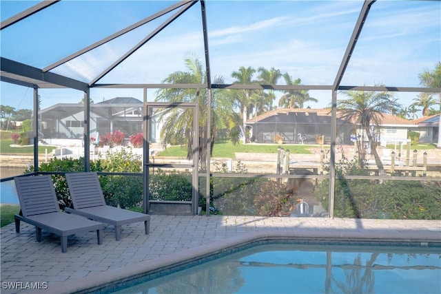 pool featuring a patio area and glass enclosure