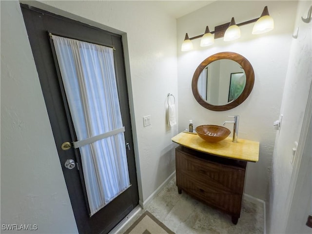 bathroom featuring vanity and baseboards