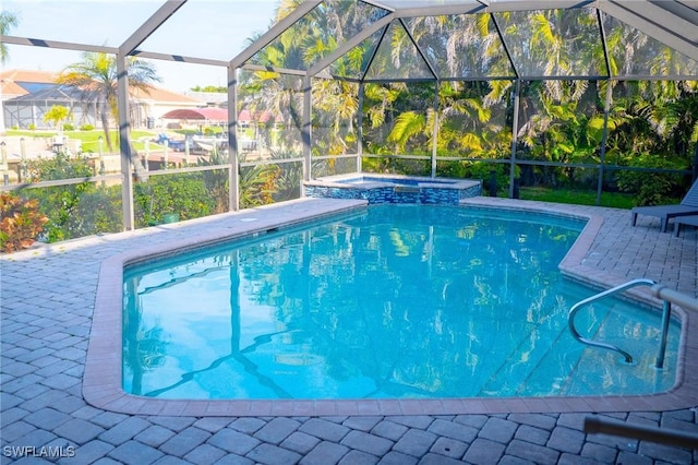 outdoor pool featuring a lanai, a patio area, and an in ground hot tub