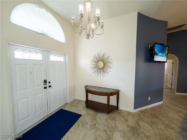 entryway with visible vents, a notable chandelier, and baseboards