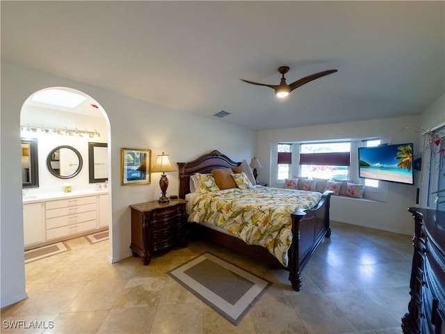 bedroom with visible vents, connected bathroom, a ceiling fan, and baseboards