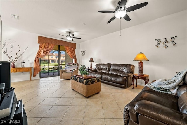 living room with light tile patterned floors, visible vents, and a ceiling fan