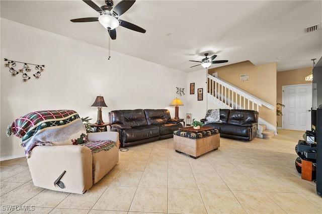 living area featuring ceiling fan, stairway, visible vents, and tile patterned floors