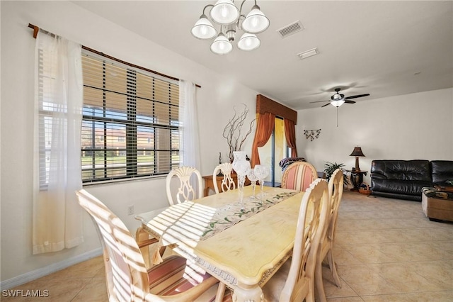 dining area with ceiling fan with notable chandelier, visible vents, and light tile patterned flooring