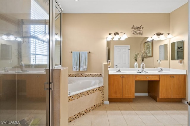 bathroom with double vanity, a stall shower, a sink, a bath, and tile patterned floors