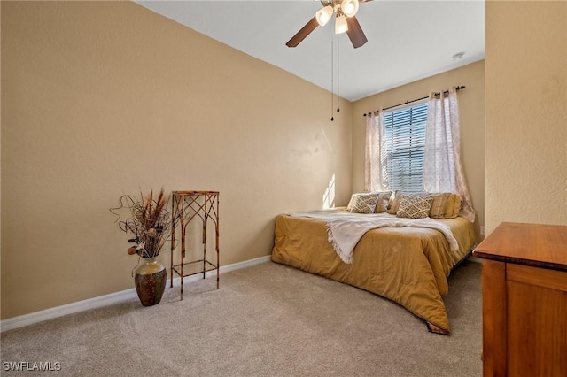 bedroom with ceiling fan, vaulted ceiling, carpet flooring, and baseboards