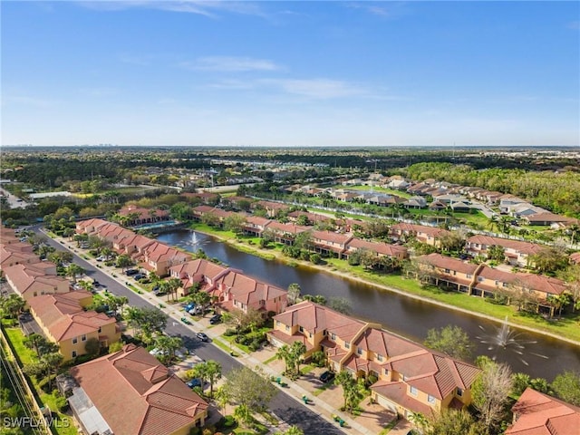 drone / aerial view featuring a water view and a residential view