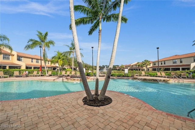 community pool featuring a patio area and a residential view