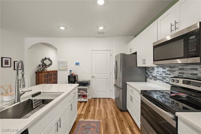 18512 Marlin Kite Ln, North Fort Myers, FL 33917 - kitchen with white cabinets, appliances with stainless steel finishes, and light countertops