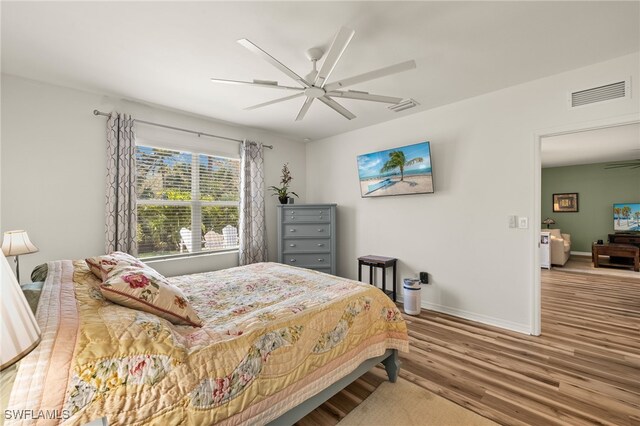 18512 Marlin Kite Ln, North Fort Myers, FL 33917 - bedroom with ceiling fan, wood finished floors, visible vents, and baseboards