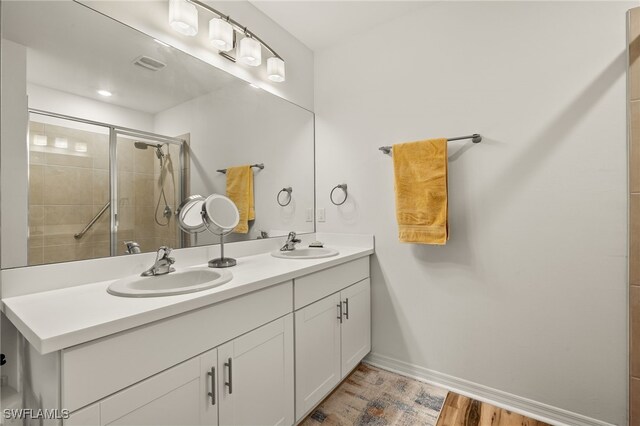 18512 Marlin Kite Ln, North Fort Myers, FL 33917 - bathroom featuring baseboards, a sink, visible vents, and a shower stall