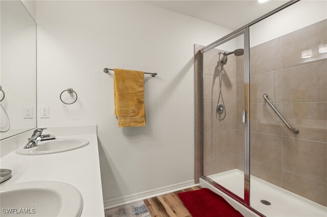 18512 Marlin Kite Ln, North Fort Myers, FL 33917 - bathroom with a stall shower, baseboards, a sink, and wood finished floors