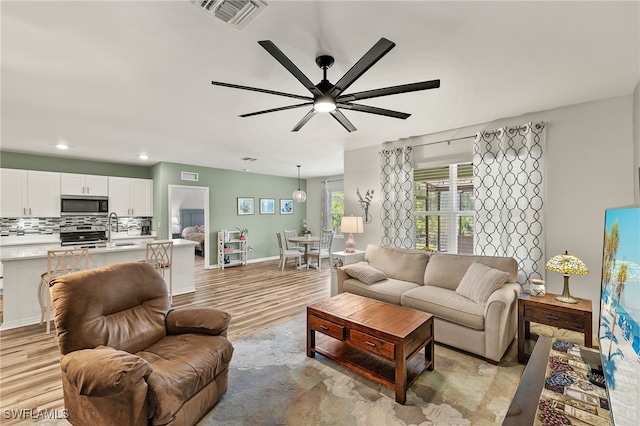 18512 Marlin Kite Ln, North Fort Myers, FL 33917 - living room featuring recessed lighting, visible vents, light wood-style floors, ceiling fan, and baseboards