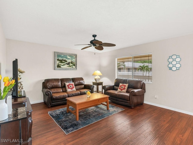 living room with ceiling fan, dark wood finished floors, and baseboards