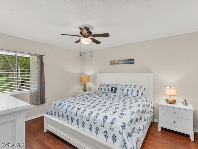 bedroom with ceiling fan, baseboards, and wood finished floors