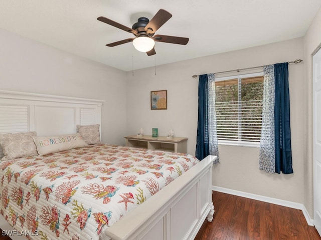 bedroom featuring ceiling fan, dark wood finished floors, and baseboards