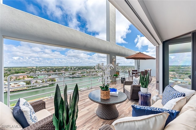 interior space featuring outdoor lounge area and a water view