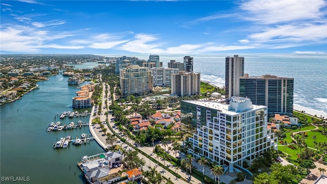 birds eye view of property featuring a water view and a view of city