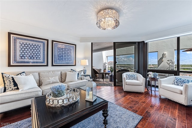 living room with ornamental molding, floor to ceiling windows, a notable chandelier, and hardwood / wood-style flooring