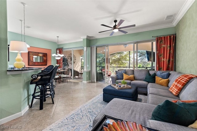 tiled living room featuring ornamental molding, visible vents, baseboards, and a ceiling fan