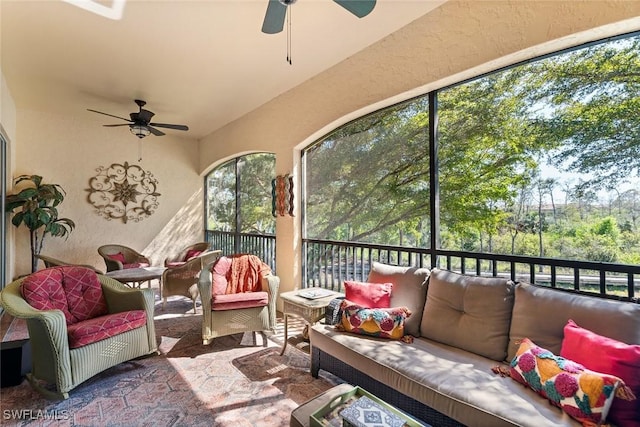 sunroom / solarium with a ceiling fan