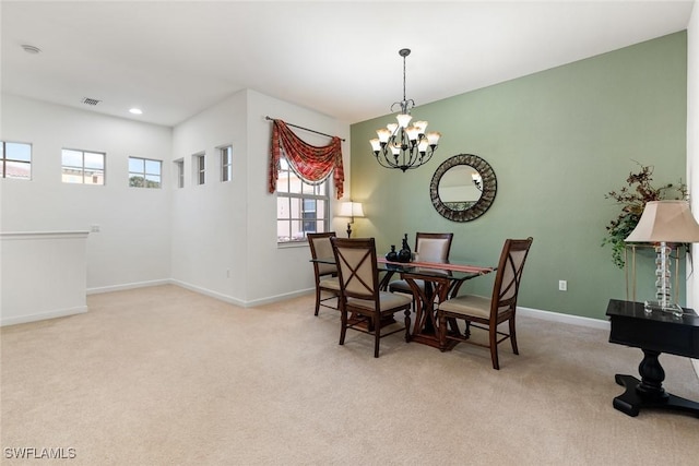 carpeted dining room with baseboards, recessed lighting, visible vents, and an inviting chandelier