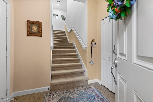 foyer with stairway and baseboards