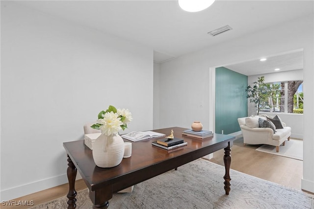 home office with visible vents, baseboards, and wood finished floors