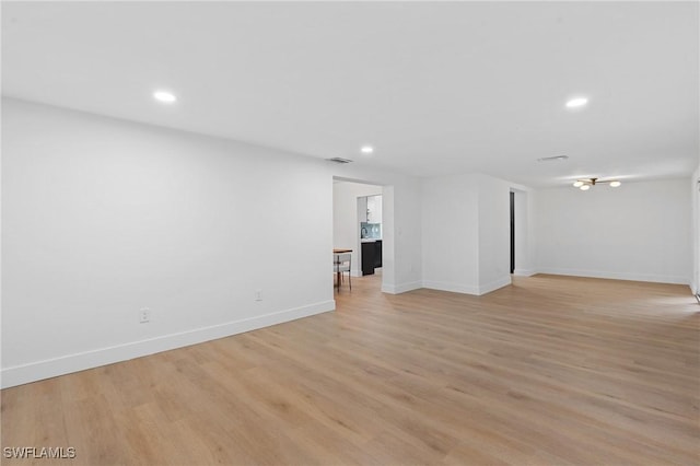 interior space featuring recessed lighting, baseboards, visible vents, and light wood finished floors