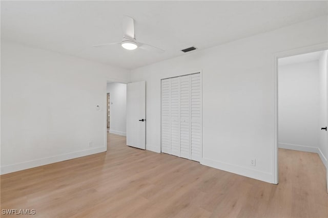 unfurnished bedroom with light wood-style flooring, visible vents, ceiling fan, and baseboards