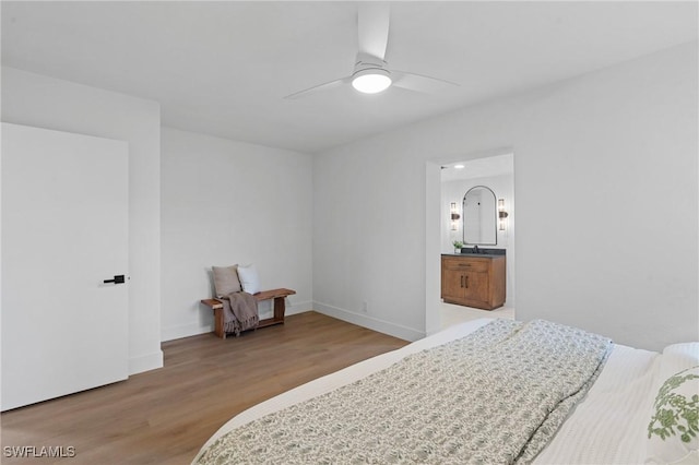 bedroom with a ceiling fan, baseboards, and wood finished floors