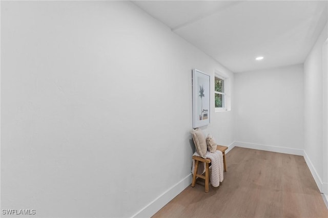 unfurnished room with light wood-style floors, baseboards, and recessed lighting