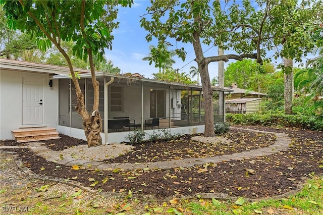 exterior space featuring entry steps and a sunroom