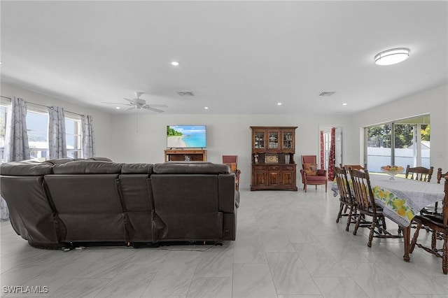 living room with plenty of natural light, visible vents, and recessed lighting