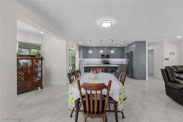 dining space with marble finish floor, recessed lighting, and baseboards