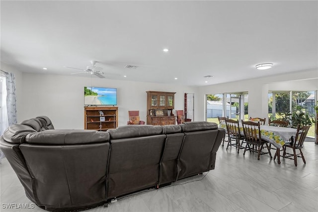 living area featuring visible vents, a ceiling fan, and recessed lighting