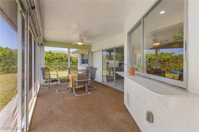 sunroom / solarium featuring ceiling fan