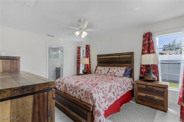 bedroom featuring a ceiling fan, visible vents, and ensuite bathroom