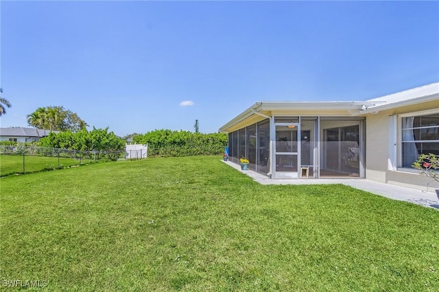 view of yard with a sunroom and fence