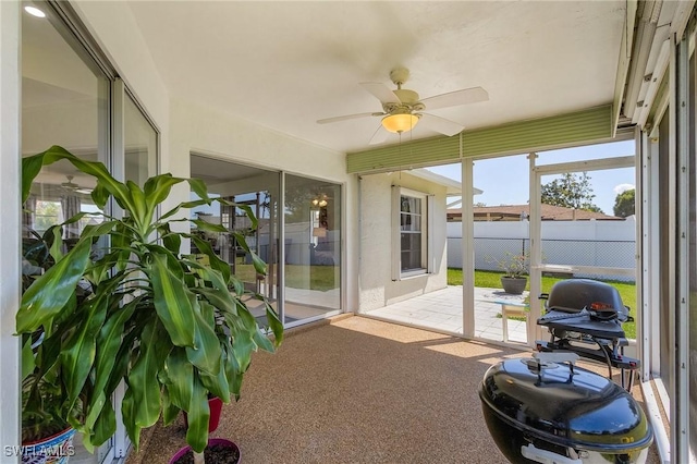 sunroom with a ceiling fan