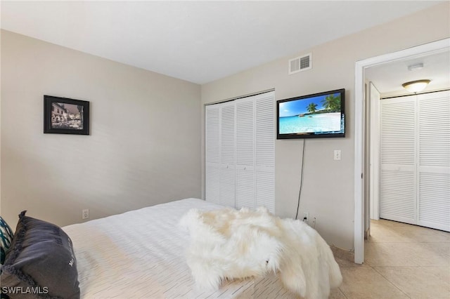 bedroom featuring light tile patterned floors and visible vents