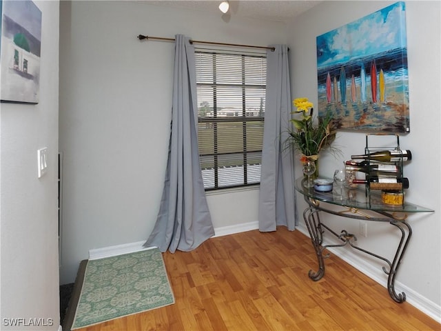 doorway to outside with light wood-style floors and baseboards