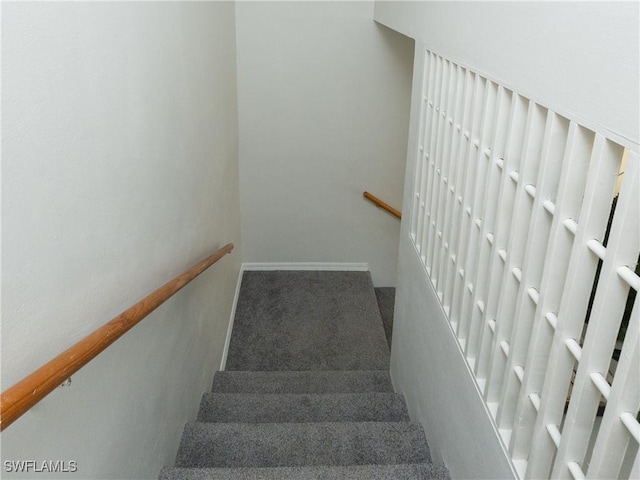 stairs featuring carpet and baseboards