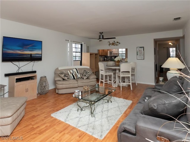 living room with wood finished floors and visible vents