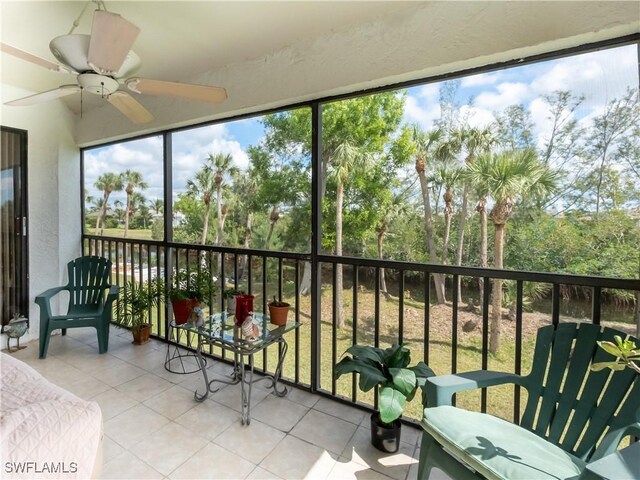 sunroom / solarium featuring ceiling fan