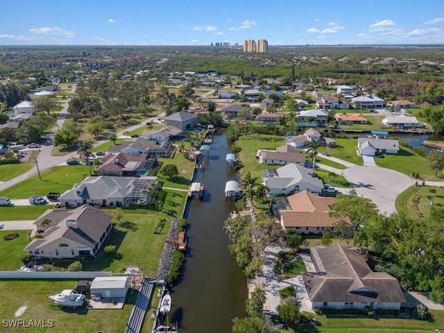 drone / aerial view with a residential view and a water view