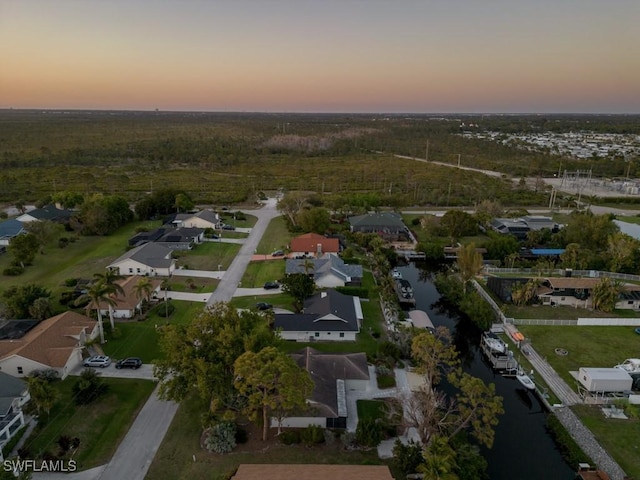 birds eye view of property with a water view and a residential view