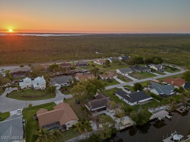 birds eye view of property with a residential view and a water view